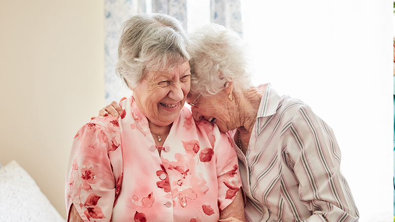 two happy seniors laughing together