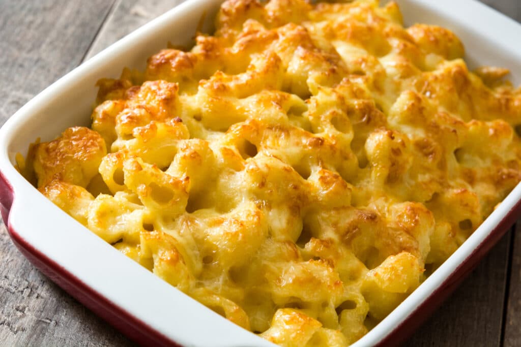 Typical American macaroni and cheese on wooden table. Close up